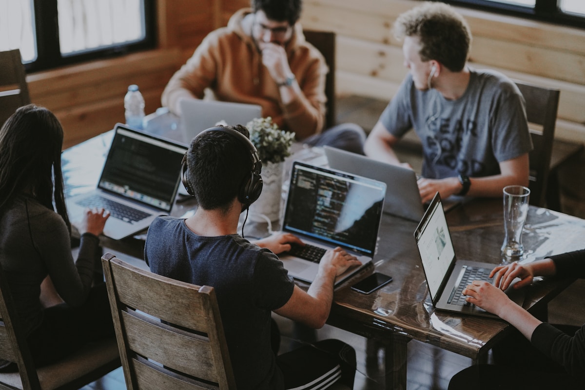 Development team coding together on laptops, representing hired WordPress developers