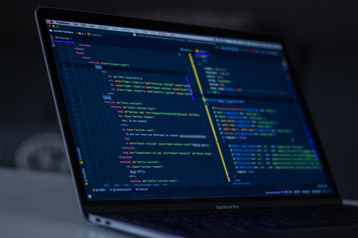 PHP and HTML in a code editor on a laptop, representing custom WordPress plugin development