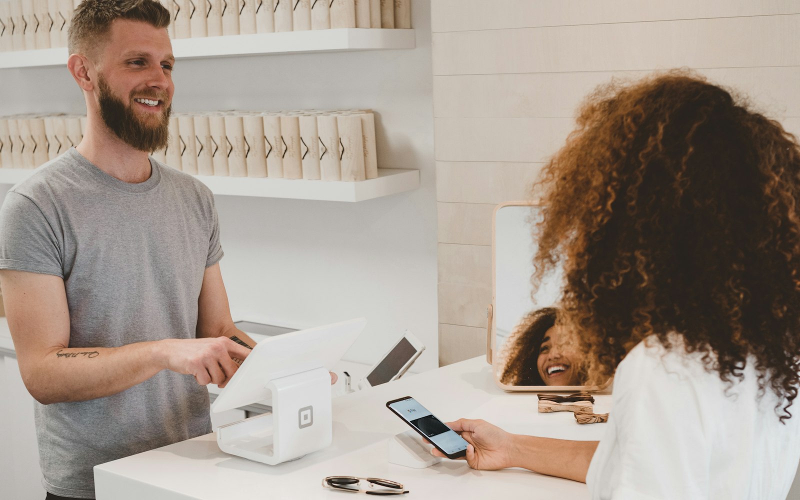 Store checkout with a tablet POS and contactless payment, representing WooCommerce store setup
