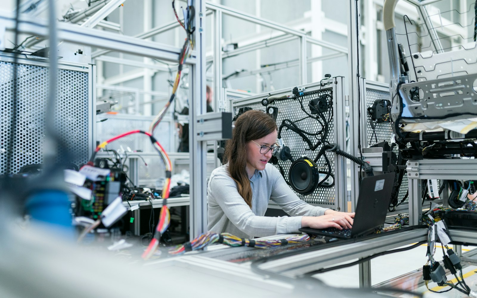 Engineer working on a laptop in a technical lab, representing WordPress updates, backups, and maintenance