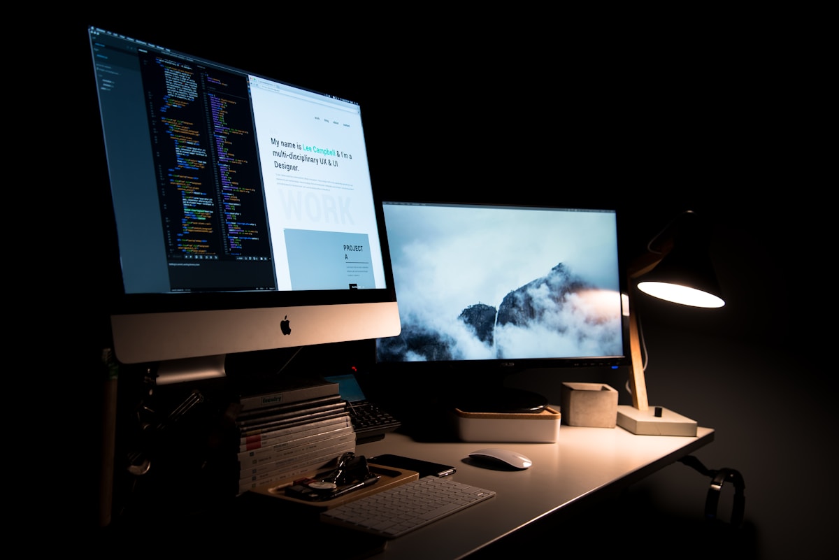 Website design and code shown side by side on a desktop, representing a WordPress redesign